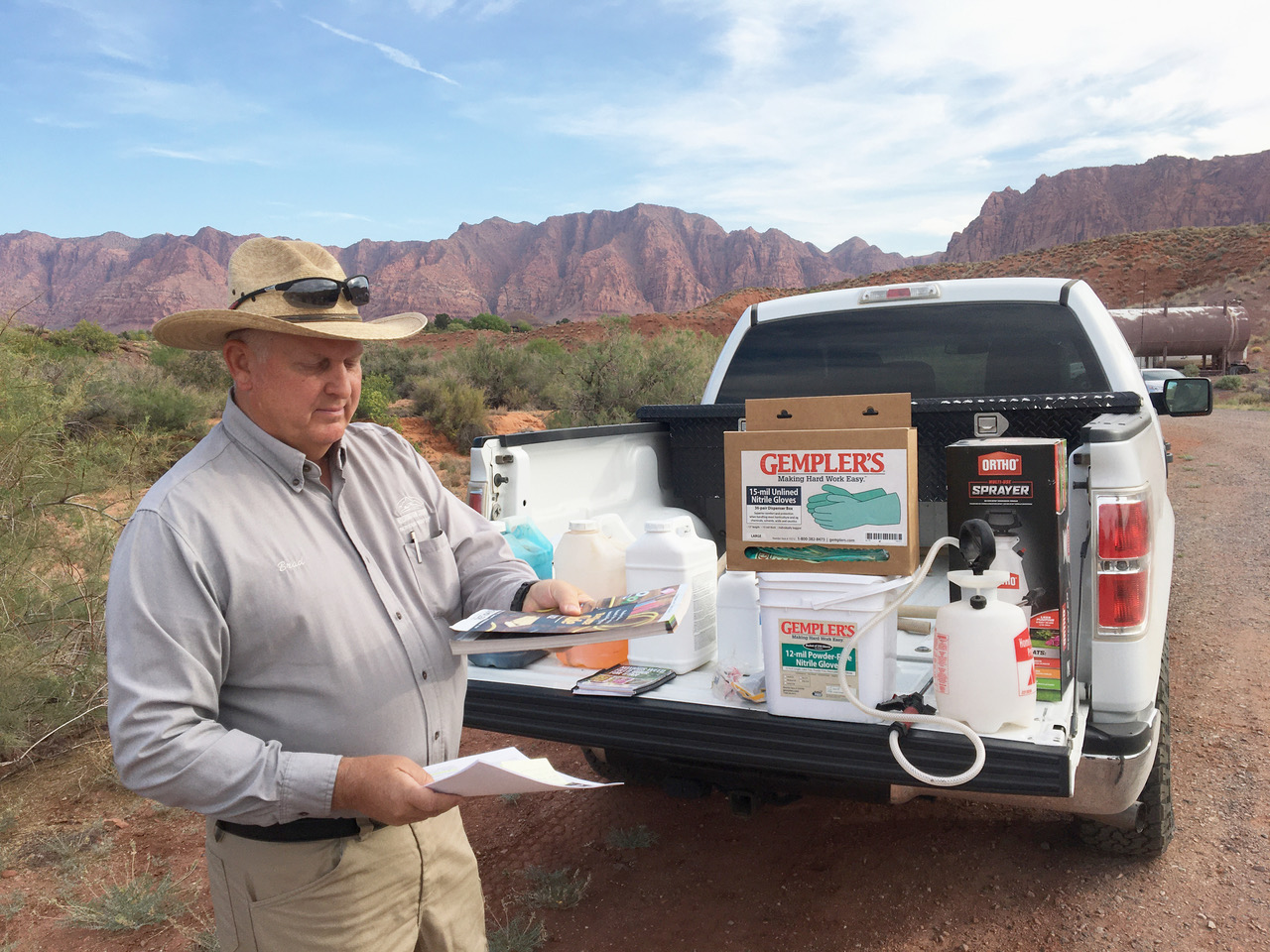 Washington county noxious weeds trainer Brad Winder. Standing in front of his truck full of herbicides in the desert
